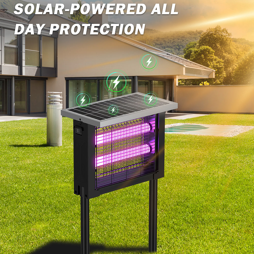 Solar-powered insect repellent on grass with house and trees in the background