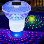 Colorful LED pool light with solar panel on top, casting vibrant lights underwater.