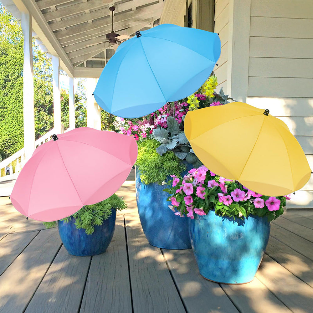 Three colorful umbrellas over flower pots on a wooden deck.