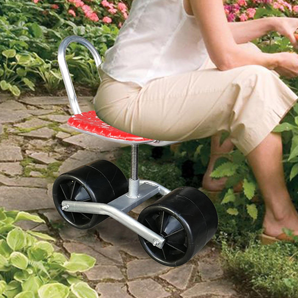 Person sitting on a small, wheeled stool in a garden setting