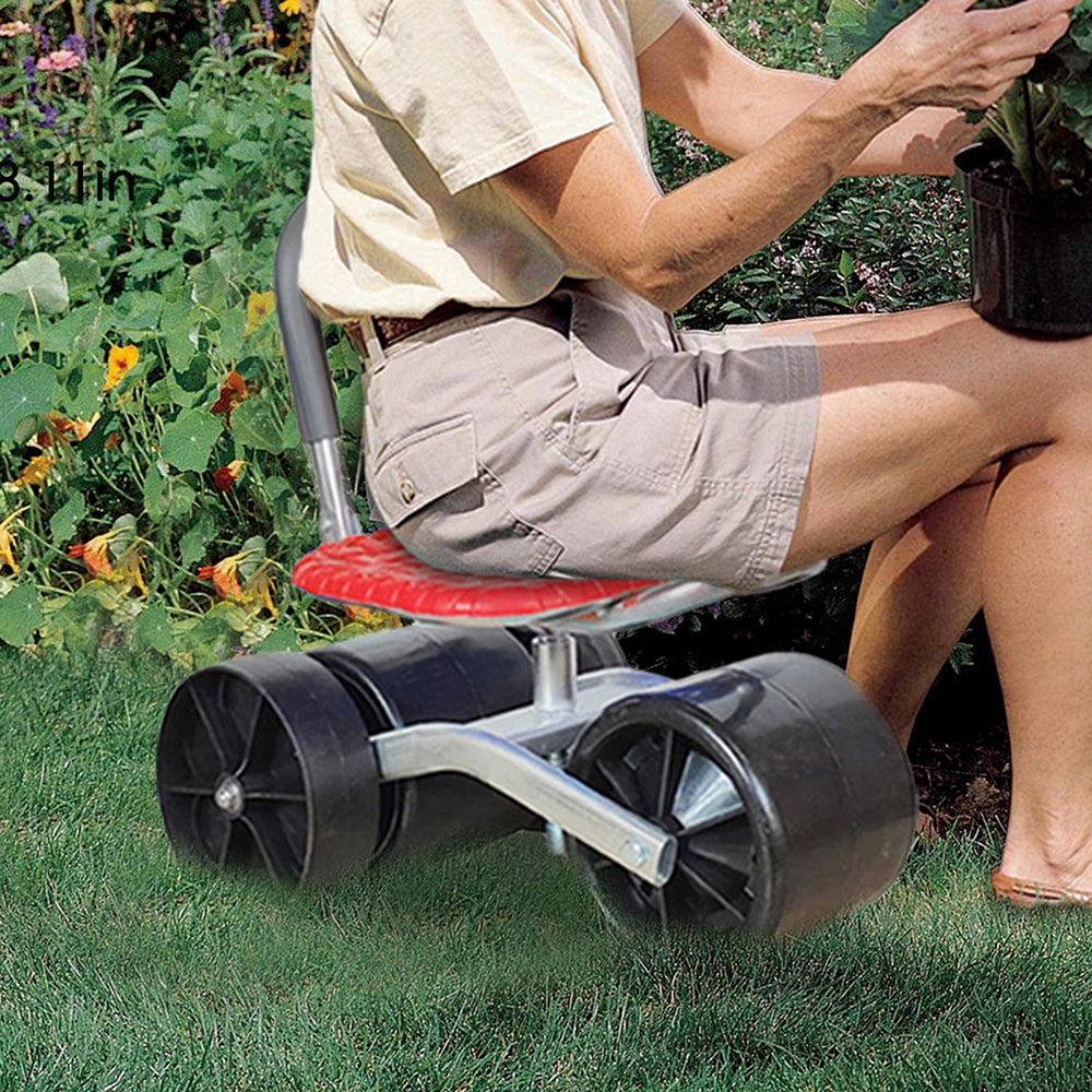 Person using a lawn roller on grass with plants in the background