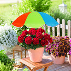 Colorful umbrella over a potted plant on a wooden deck with garden background