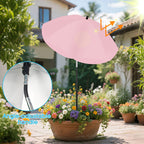 Pink patio umbrella with adjustable handle in a garden setting