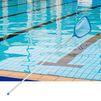 Pool skimmer net on a pool deck with clear blue water