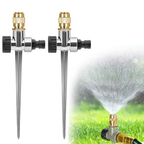 Two garden sprinklers with water spraying onto grass