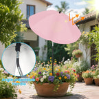 Pink patio umbrella with adjustable handle in a garden setting