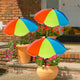 Colorful umbrellas protecting potted plants on a porch.