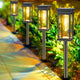 AxiaTool solar pathway lights illuminating a garden pathway with warm, glowing LED lights at dusk.