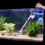 Person using an aquarium cleaning tool inside a fish tank with plants and gravel.