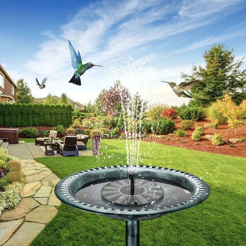Solar-powered water fountain with birds in a garden setting