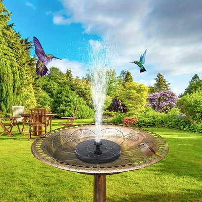 Solar-powered water fountain with bird bath in a garden setting