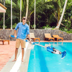 Man cleaning a pool with a pool vacuum in a tropical setting