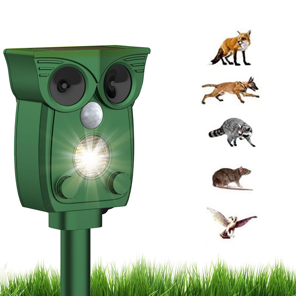 Green owl-shaped device with a light on a grassy background, featuring images of animals above it.